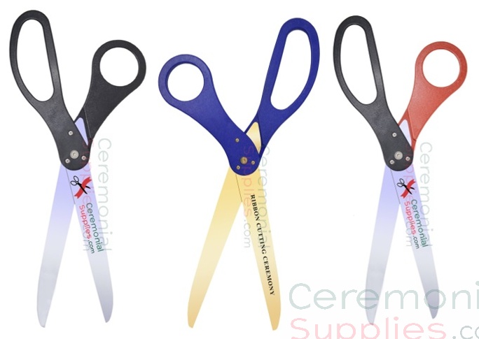 Three scissors of varying colors standing vertically next to each other.