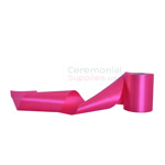 Plain hot pink grand opening ribbon in unrolled and swirly pose.