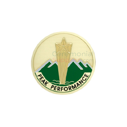 Image of a peak performance medal with a gold shooting star in the center and green mountains in the background