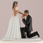 Photo of a medium tone On One Knee Bride and Groom Cake Topper.