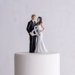 View of a Mr & Mrs Figurine Cake Toppers on a cake.
