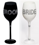 Photo of the Bride and Groom wine glasses in decorative embellishments.