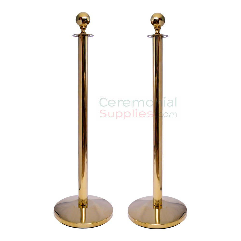 two gold stanchions with ball top