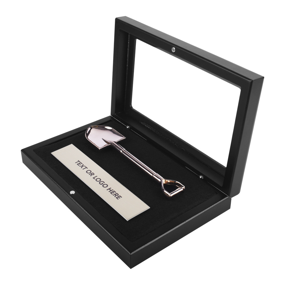 small display case with mini shovel and plaque