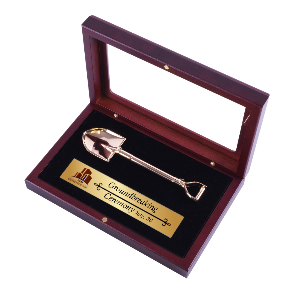 mini groundbreaking shovel and small plaque in display case