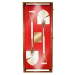 Front of Clear Case with two shovels and plaque