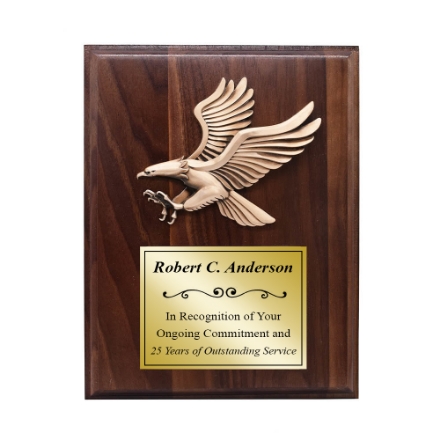Brass eagle on a wooden plaque with gold plate for printing Brass eagle on a wooden plaque with gold plate for printing
